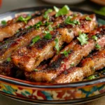 Grilled strips of skirt steak are garnished with parsley and served on a colorful plate.